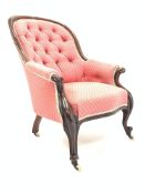 Victorian mahogany framed button back upholstered armchair, scroll carved arm terminals,