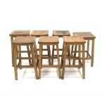 Set six 20th century oak lab stools, and another similar stool, W36cm, H60cm,