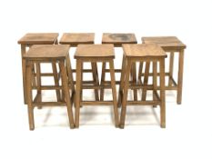 Set six 20th century oak lab stools, and another similar stool, W36cm, H60cm,