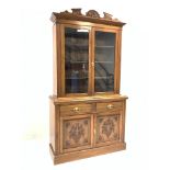 Edwardian walnut bookcase on cupboard,