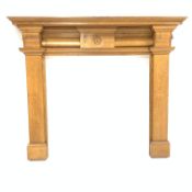 20th century light oak fire surround with cushion moulded frieze flanking carved Yorkshire rose,