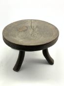 African Tribal stool with dished circular seat and splay supports,