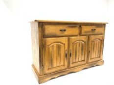 20th century light oak sideboard, with two drawers above two panelled cupboards,