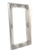 Large 20th century upright wall mirror in ornate swept silver frame, with bevelled plate,