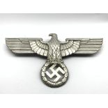 Third Reich Nazi Germany cast metal insignia, eagle with spread wings above wreath,
