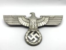 Third Reich Nazi Germany cast metal insignia, eagle with spread wings above wreath,