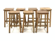 Set six 20th century oak lab stools, and another similar lab stool, (W36cm, H49cm,