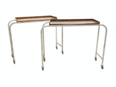 Pair 20th century trolleys, with elm veneered tray tops raised on steel supports and castors,