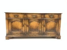 18th century style solid oak dresser base, with three drawers over three cupboards, panelled sides,