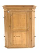 Solid pine wall hanging corner cabinet, panelled door enclosing two shaped fixed shelves, W83cm,