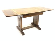 20th century light oak draw leaf table with carved panel end supports and sledge feet united by