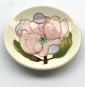 Moorcroft saucer dish decorated in the Pink Magnolia pattern on a cream ground D12cm