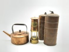 Two copper hot water bottles, copper kettle and a miners lamp with plaque reading 'E.