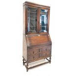 18th century style oak bureau bookcase, with leaded glazed doors enclosing three shelves,