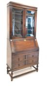 18th century style oak bureau bookcase, with leaded glazed doors enclosing three shelves,