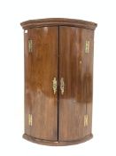 Georgian mahogany bow front wall hanging corner cupboard with original brass fittings,