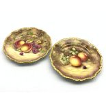 Pair of Royal Worcester cabinet plates painted with panels of fruit by R Price and S Weston with a