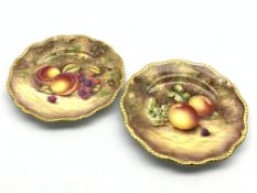 Pair of Royal Worcester cabinet plates painted with panels of fruit by R Price and S Weston with a