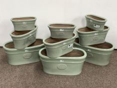 Set of nine light green glazed terracotta garden planters, various sizes,