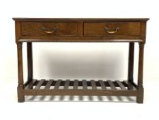18th century style oak welsh dresser base, with two drawers raised on turned supports,