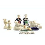 Pair of 19th Century hollow based figures of Turkish musicians H12cm, four various sheep ornaments,