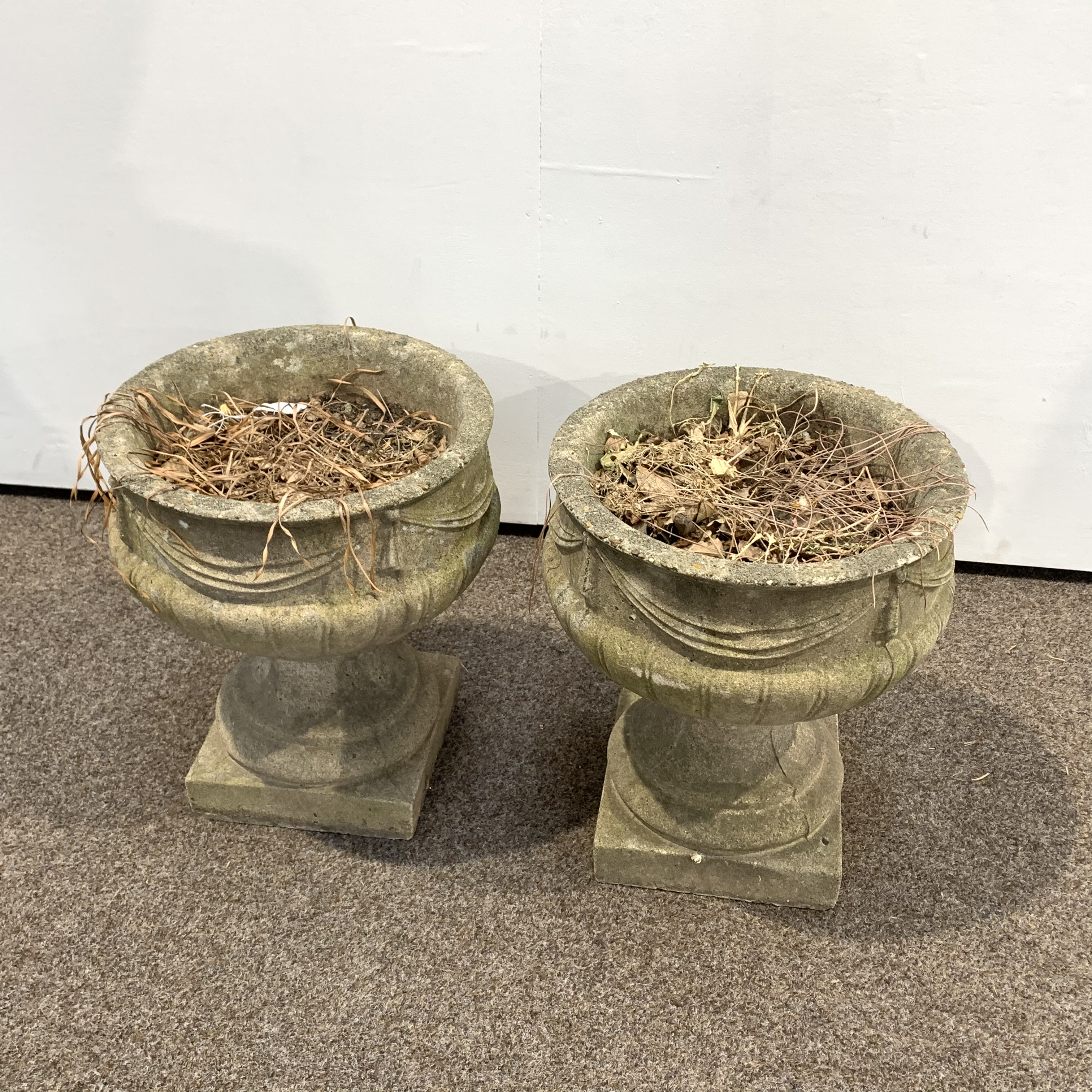 Pair of reconstituted stone garden urns decorated with ribbon swags and with lobe moulded bases, - Image 2 of 2