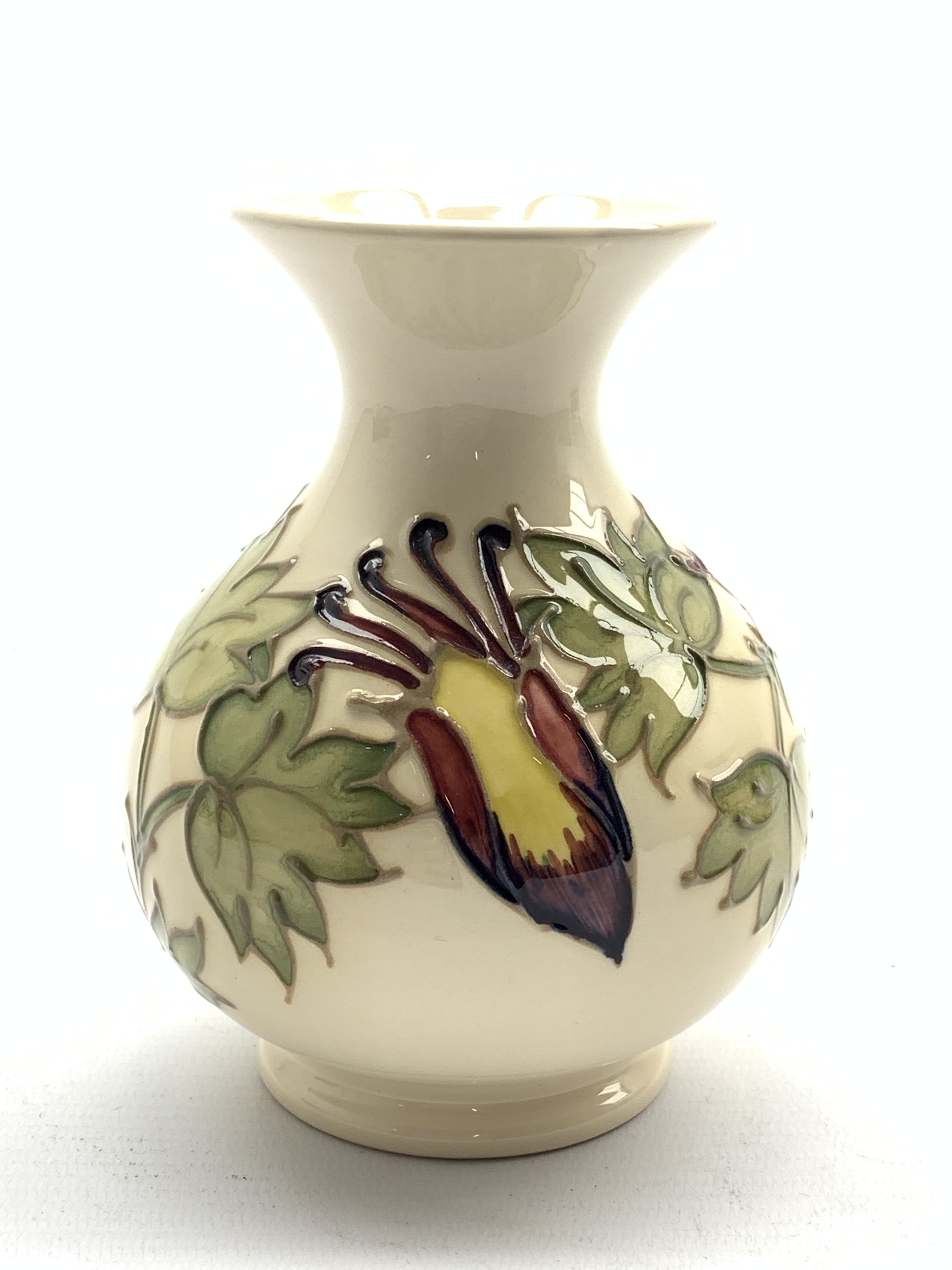Moorcroft baluster vase decorated in the Aquilegia pattern on a cream ground H13cm