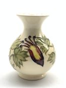 Moorcroft baluster vase decorated in the Aquilegia pattern on a cream ground H13cm