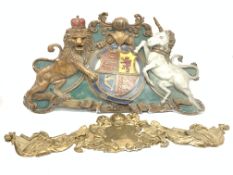 Moulded plastic coat of arms and three similar moulded plastic decorative items (4)