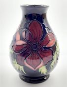 Moorcroft oviform vase decorated in the Anemone pattern on a dark blue ground H14cm