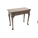 Georgian mahogany fold over tea table, with frieze drawer, raised on carved cabriole supports,