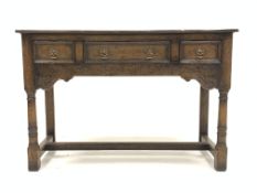 20th century carved oak dresser base with three drawers raised on turned supports united by