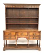 George III oak dresser, three heights plate rack fitted with cast iron hooks over five drawers,