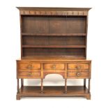 George III oak dresser, three heights plate rack fitted with cast iron hooks over five drawers,
