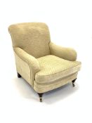 Howard style upholstered armchair, turned mahogany supports and brass cup castors,