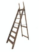 Late 19th/early 20th century stained pine simplex step ladder, the 'A' frame with seven rungs,