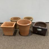 10 terracotta plant pots of varying designs,