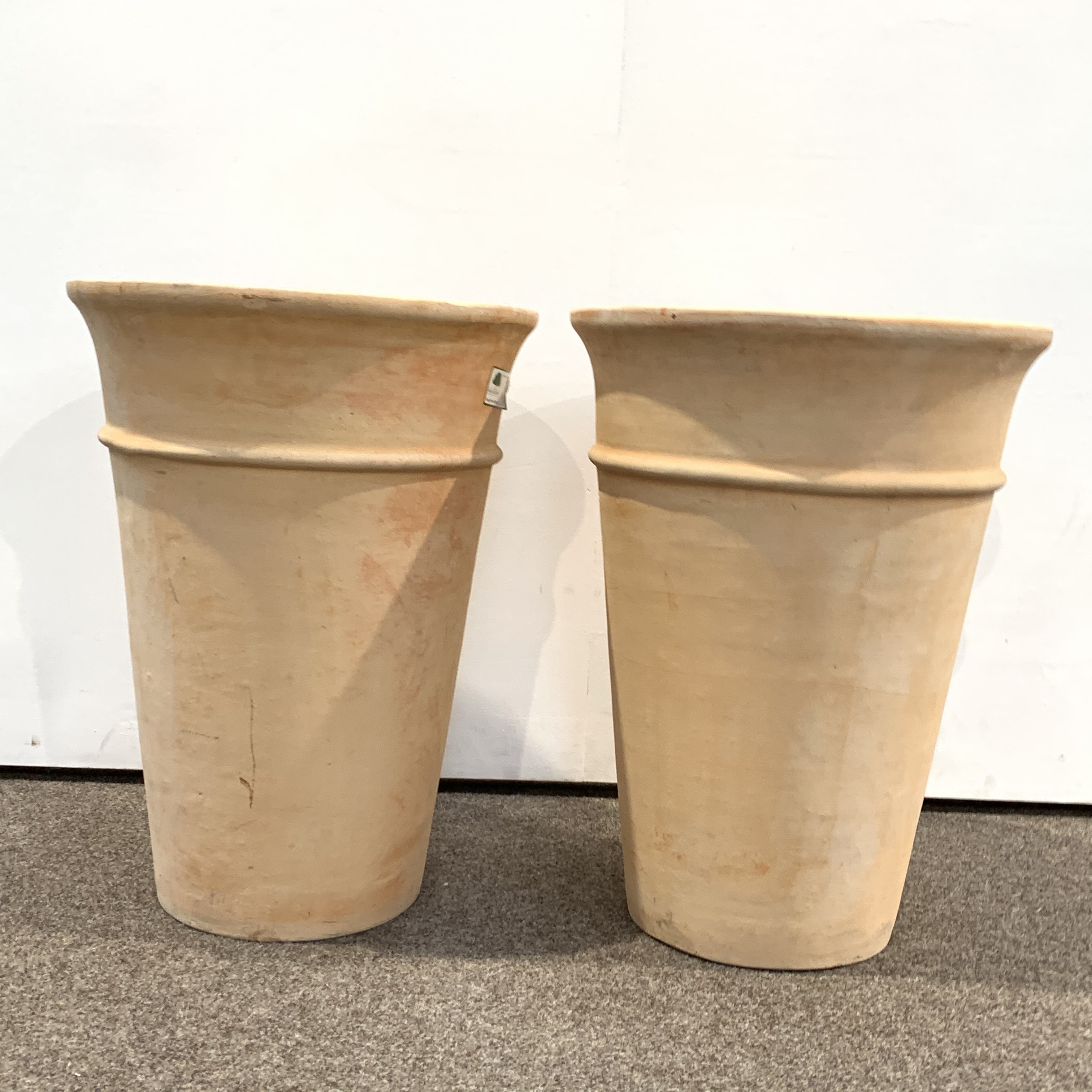 Tall pair cylindrical tapering terracotta planters,