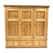 20th century solid pine triple wardrobe, interior fitted with hanging rail and shelves,