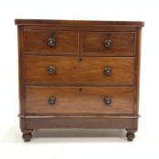 Victorian mahogany chest fitted with two short and two long drawers, raised on turned supports,