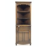 20th century carved oak corner cupboard, with two shaped shelves over panelled door, W62cm, H168cm,