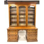 Victorian mahogany triple bookcase with three glazed doors enclosing eight adjustable shelves,