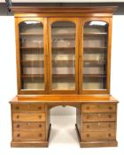 Victorian mahogany triple bookcase with three glazed doors enclosing eight adjustable shelves,
