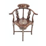 20th century hardwood oriental corner chair, with pierced and carved splats, swept arms, panel seat,