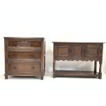 Small 20th century carved oak dresser base with two cupboards raised on turned supports with pot