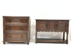 Small 20th century carved oak dresser base with two cupboards raised on turned supports with pot
