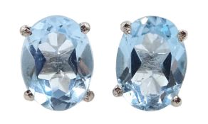 Pair of silver oval blue topaz stud earrings, stamped 925