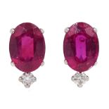 Pair of platinum oval ruby stud earrings, each set with a diamond, stamped Pt 900, ruby total weigh