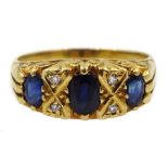 18ct gold three stone oval sapphire and four stone diamond ring, London 1974