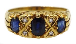 18ct gold three stone oval sapphire and four stone diamond ring, London 1974